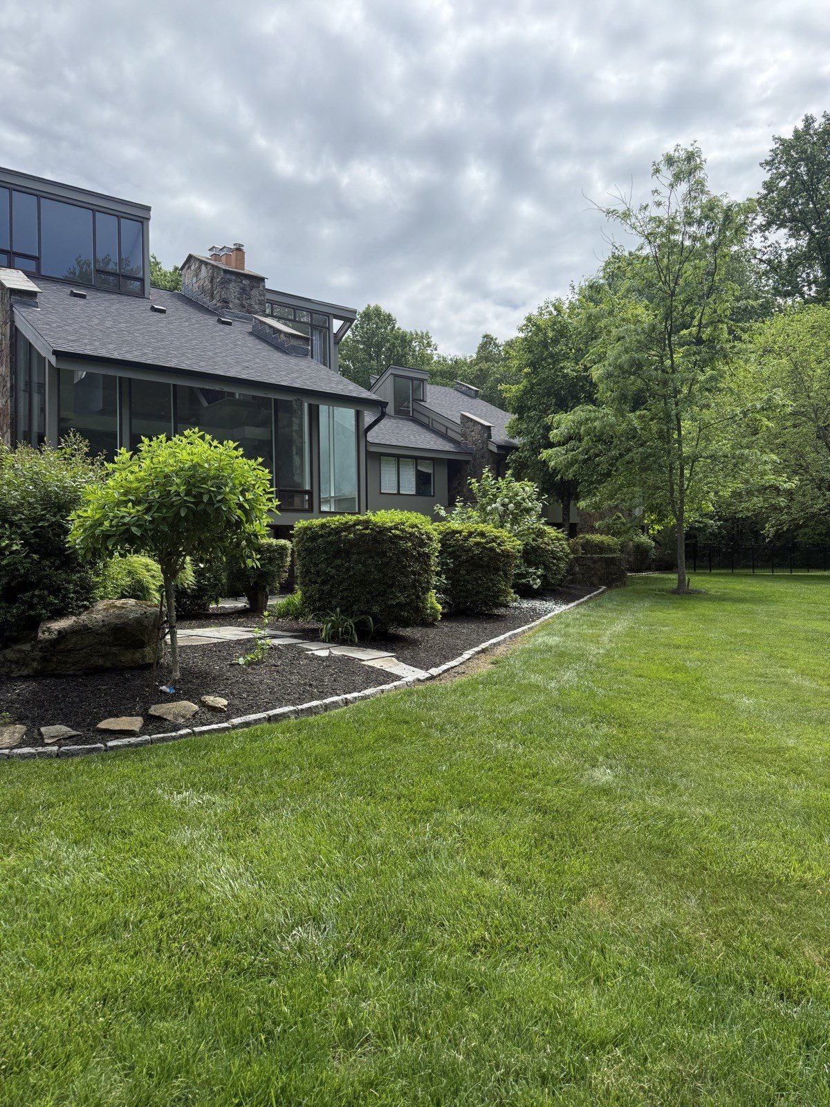 Maintained Fairfield County property with a manicured lawn and tidy landscape beds
