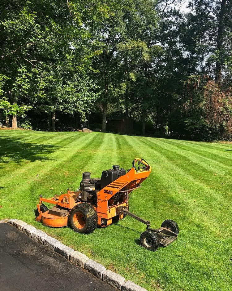 Lawn aeration equipment on a freshly striped Fairfield County lawn