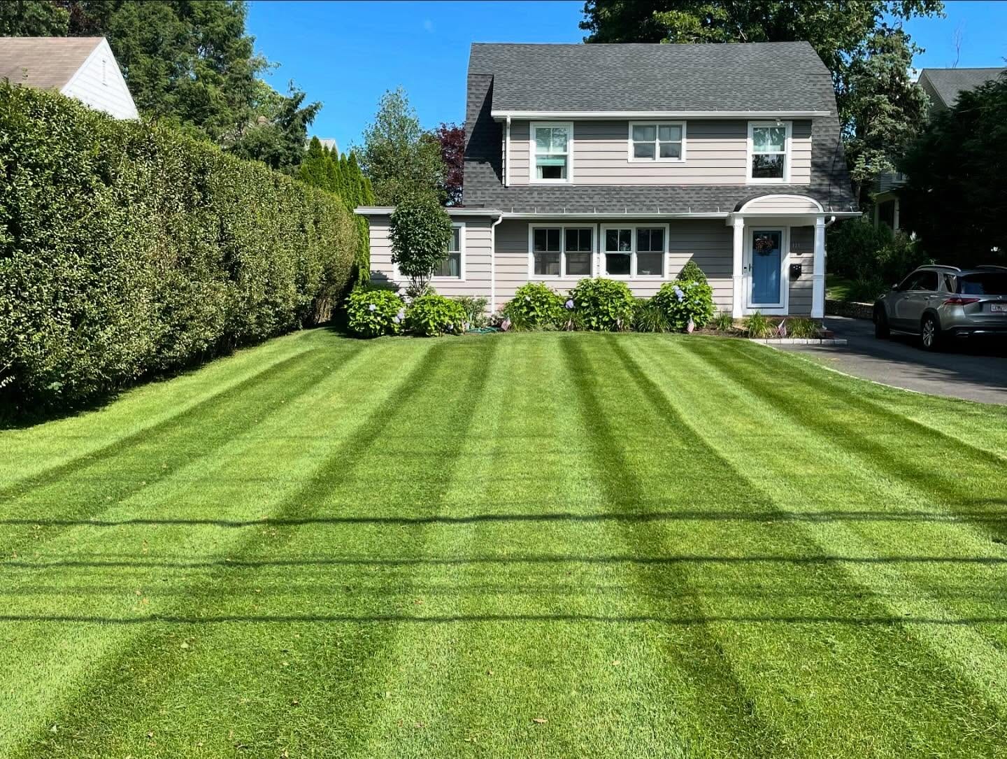 Fresh striped lawn mowing in front of a Fairfield County home