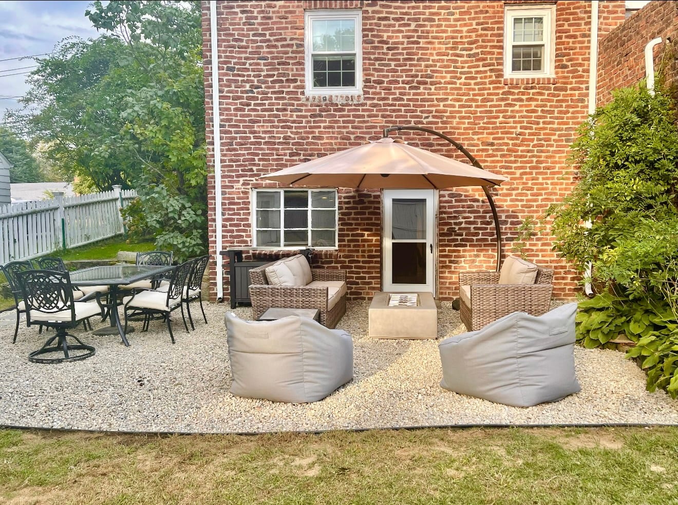 Backyard patio hardscape with seating area and foundation plantings