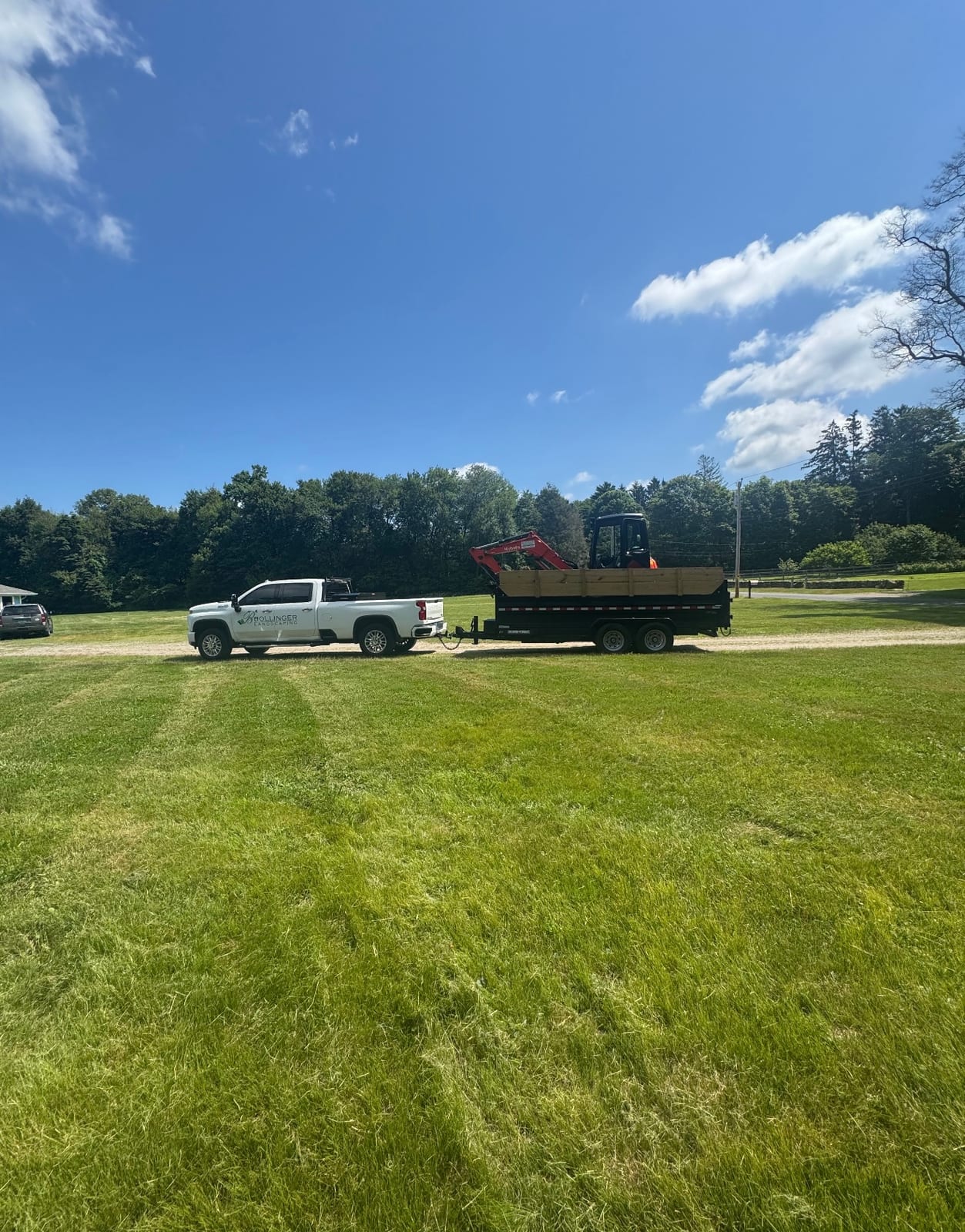 Bollinger Landscaping truck and trailer on a lawn care project